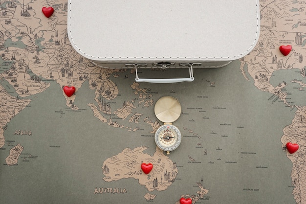 Free photo travel background with compass, suitcase and world map