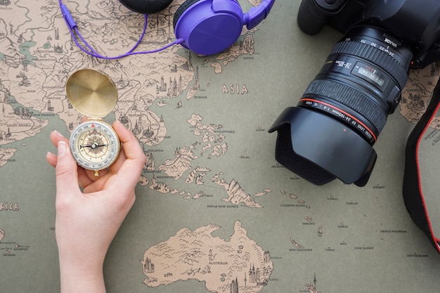 Free photo travel background with hand holding a compass