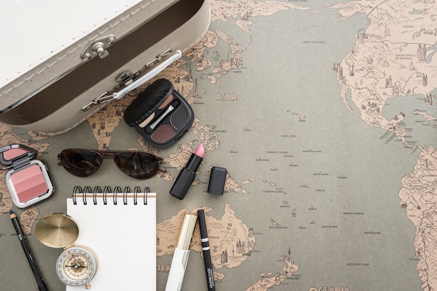 Free Photo travel background with suitcase and beauty accessories