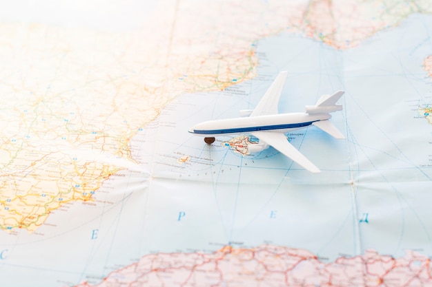 Travel background with toy plane on map