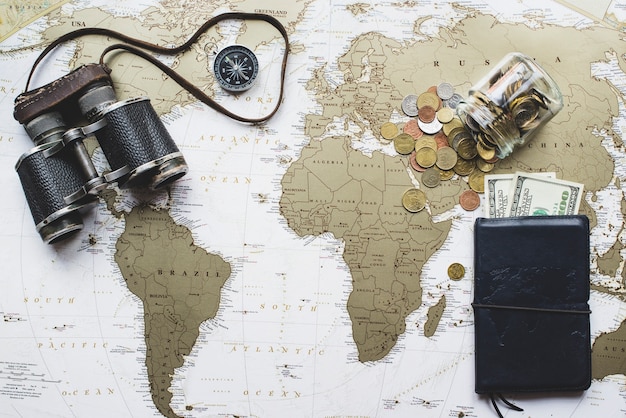 Free Photo travel background with world map, money and binoculars