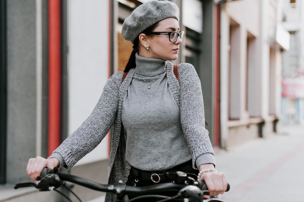 Free Photo travel in the city life with bicycle woman looking away