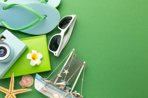 Travel items on green background