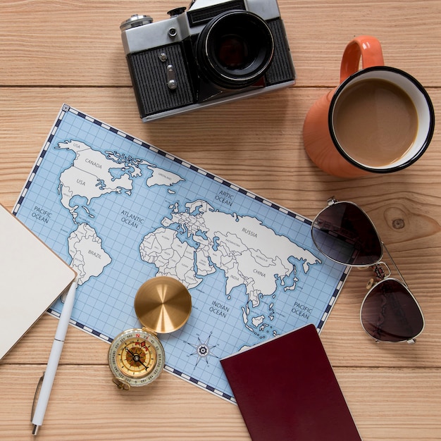 Free Photo travel items on wooden background flat lay