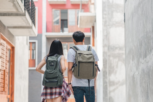 Traveler Asian backpacker couple feeling happy traveling in Beijing, China, cheerful young teenager couple walking at Chinatown. 