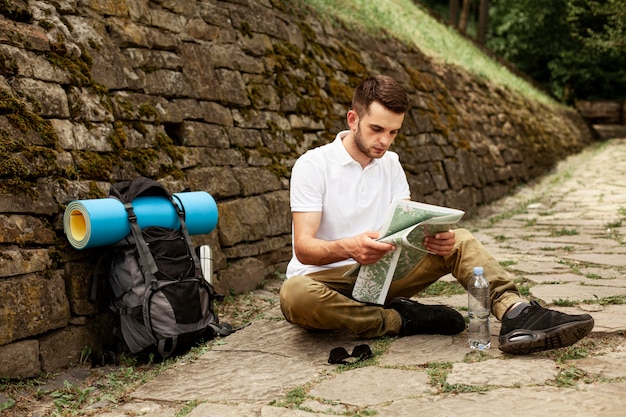 Traveler consulting map while resting