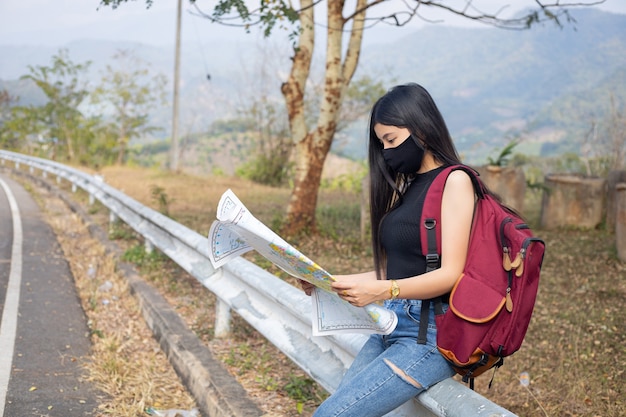 Traveler girl searching right direction on map