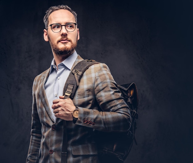 Traveler. Studio portrait of a handsome bearded man wearing a ca