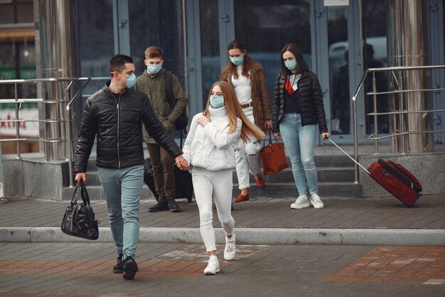 Travelers leaving airport are wearing protective masks