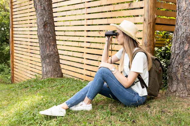 Free photo traveller looking through binoculars