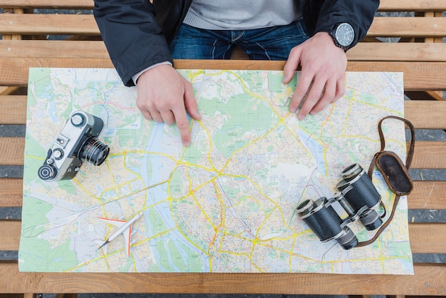 Free photo traveller pointing at map