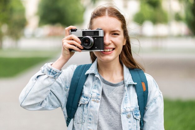 Traveller taking a photo with retro camera