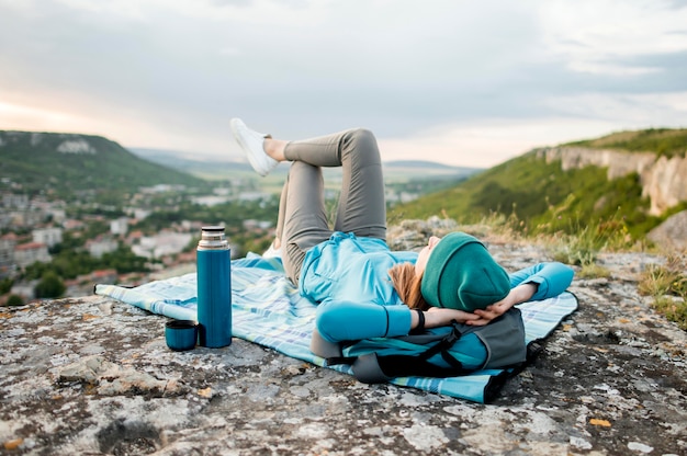 Traveller with beanie relaxing outdoors