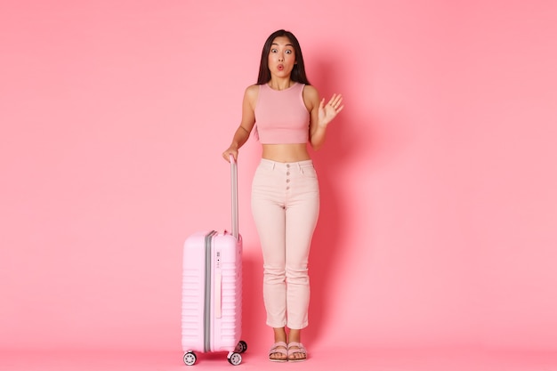 Travelling, holidays and vacation concept. Silly and cute asian girl in summer clothes meeting girlfriends in airport