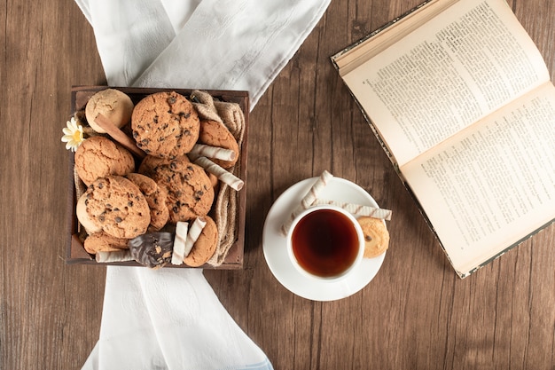 A tray of cookies and a cup of tea. top view