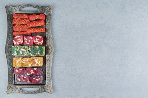 Tray full of appetizing Turkish delight on the marble background. High quality photo