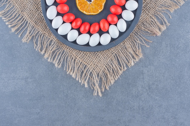 A tray full of gums and leaves, on the trivet, on the marble background. 