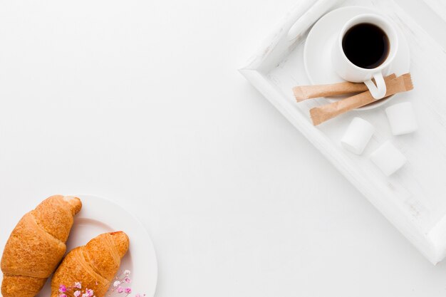 Tray with cup of coffee and croissant