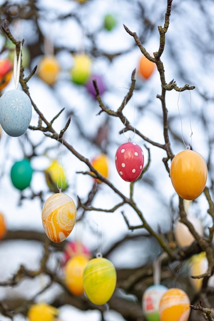 Free photo tree decorated with colorful easter eggs street easter decor