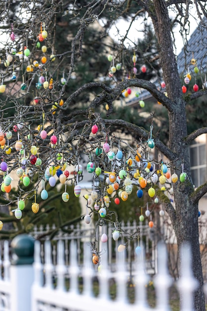 Free photo tree decorated with colorful easter eggs street easter decor