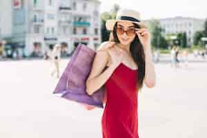 Free photo trendy flirty model with shopping bags