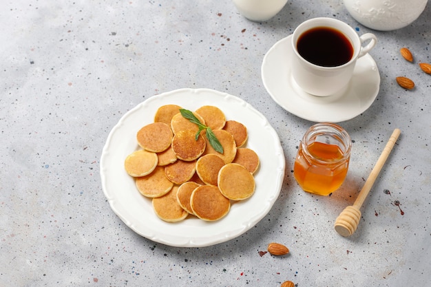 Free photo trendy food - mini pancake cereal. heap of cereal pancakes