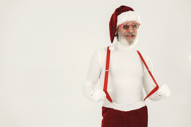 Trendy grey-haired santa. Man wear knitted clothes. Grandfather in a santa's hat.