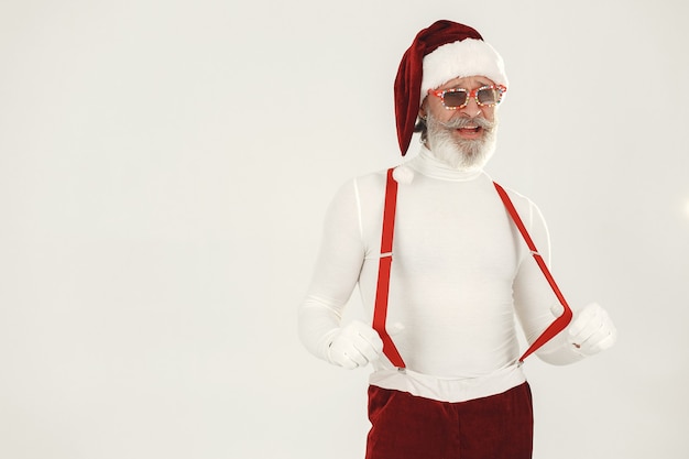 Trendy grey-haired santa. Man wear knitted clothes. Grandfather in a santa's hat.