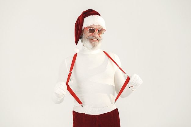 Free Photo trendy grey-haired santa. man wear knitted clothes. grandfather in a santa's hat.