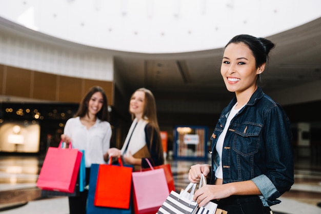 Trendy model with shopping bags in mall