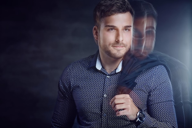 Free photo trendy young man in shirt with jacket on his shoulder.