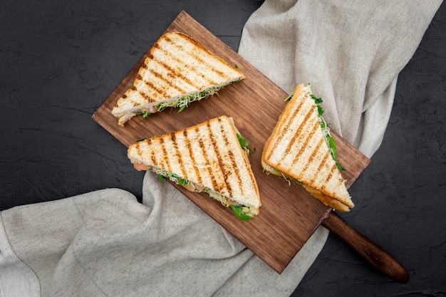 Triangular sandwiches on chopping board