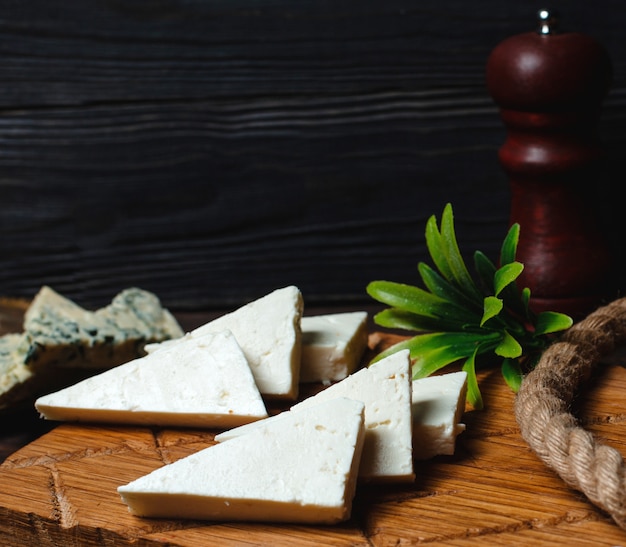 Triangulated white cheese on a wooden board