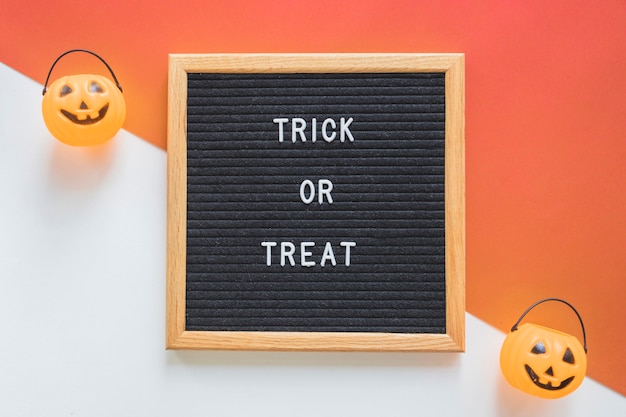 Free photo trick or treat baskets near frame with writing