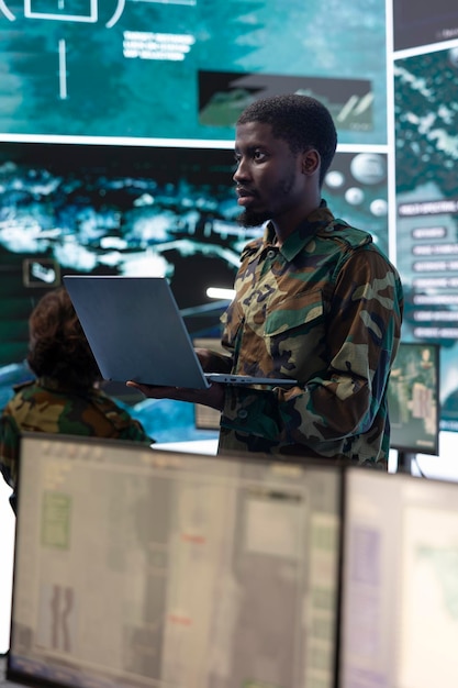 Free photo trooper monitors chroma key mockup display on a laptop in general headquarters