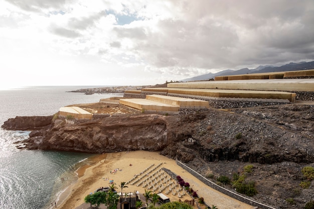 Tropical beach with cliffs on background