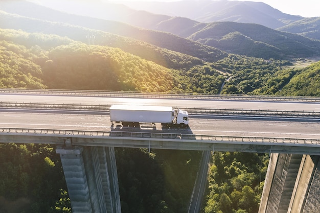 trucks on highway in mountain at sunset