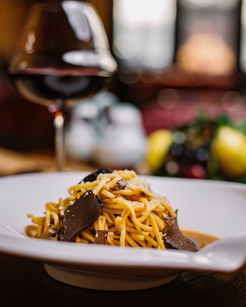 Free Photo truffle spaghetti plate with mushroom sauce and grated parmesan