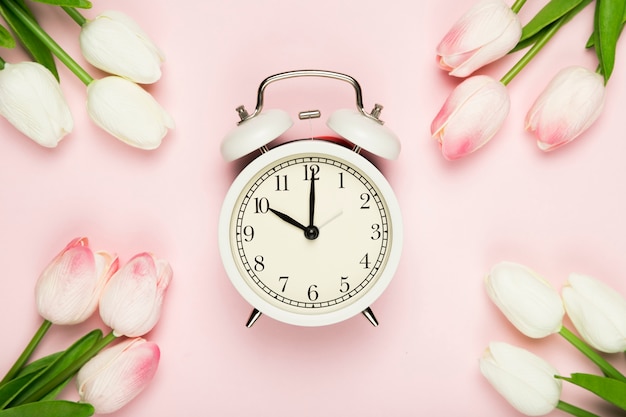 Free photo tulips frame with clock in the middle