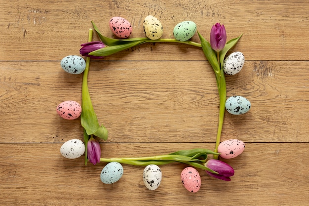 Free photo tulips and painted eggs frame