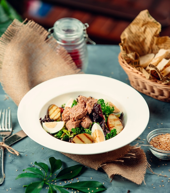 Tuna salad with boiled eggs and arugula