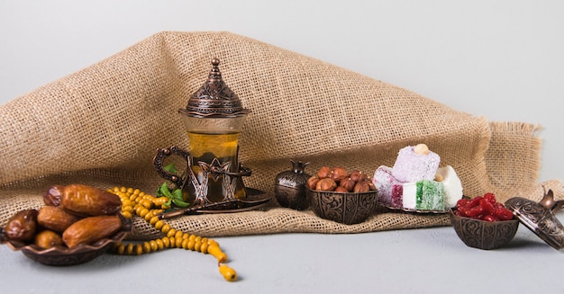 Free photo turkish delight with tea glass and dates fruit