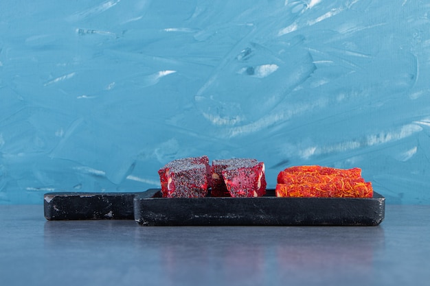 Turkish delights on a board on the marble surface