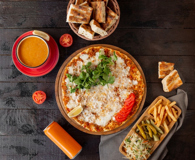 Free Photo turkish lahmajun with cheese, served with lemon, parsley with tomato soup