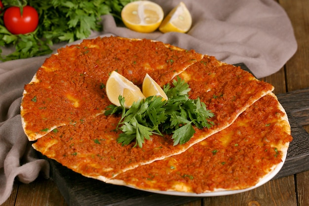 Turkish lahmajun with greens and a slice of lemon