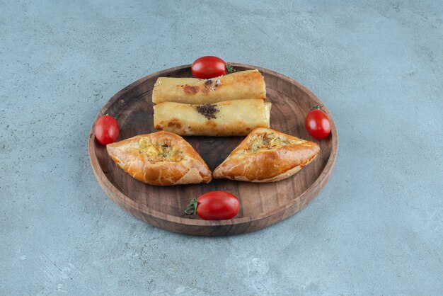 Turkish pide and russian blins on a small tray on marble surface