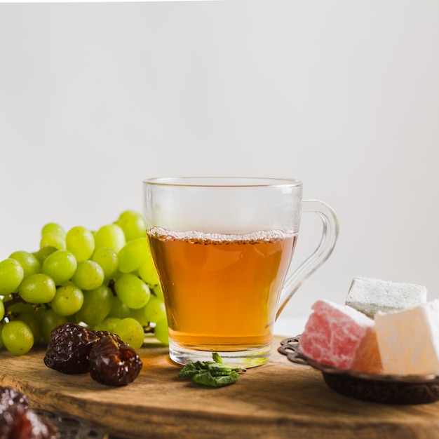 Free photo turkish tea in mug with sweets and fruit