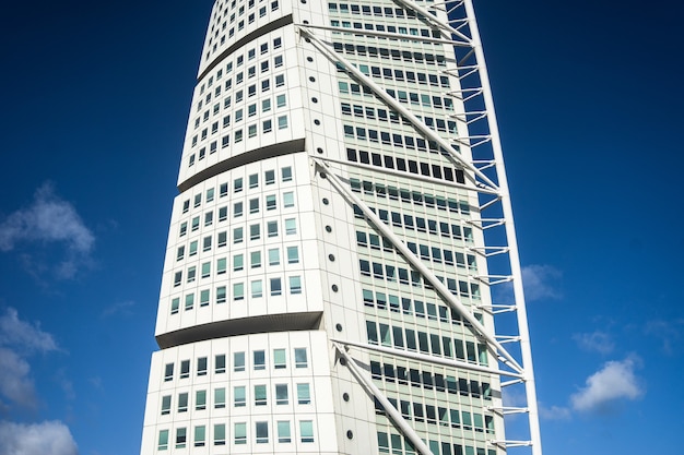 Turning Torso under a blue sky and sunlight during daytime in Malmo in Sweden