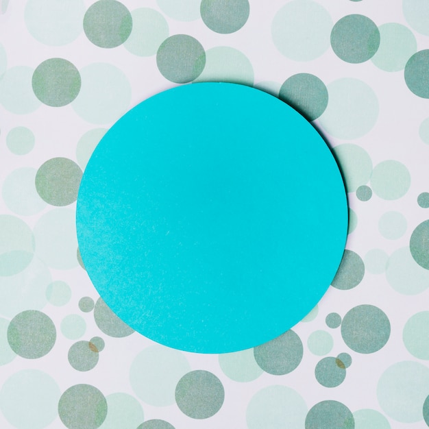 Turquoise circular frame on dot backdrop