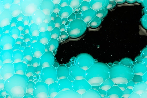 Turquoise foam on black water